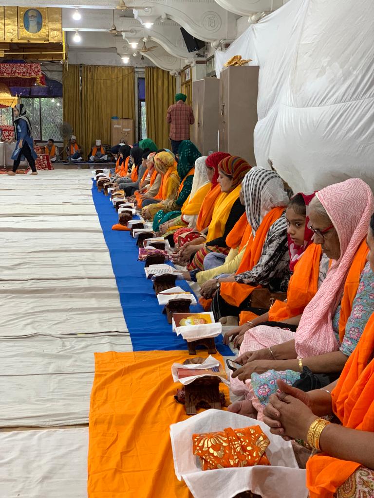 Rows of women seated together for a programme